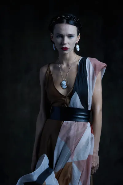 Model wearing a silver pendant with a hand-carved shell cameo