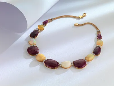 Necklace with purple and milky white stones set in gold
