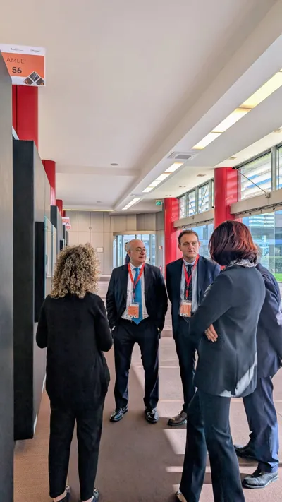 Participants talking in a corridor of the exhibition centre.