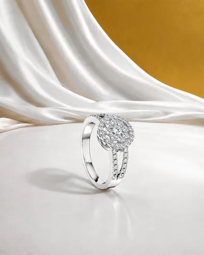 Diamond ring from the Clock collection on white satin