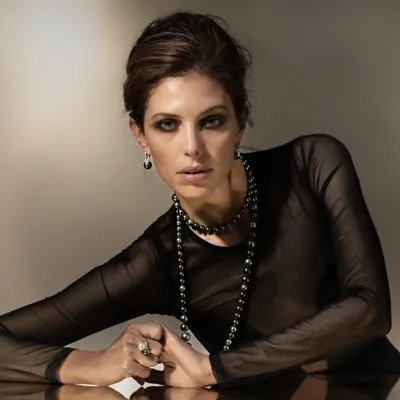 Model wearing a necklace, earrings and ring in 18-karat white gold with Tahitian and freshwater pearls and diamonds