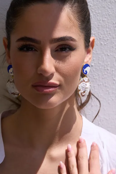 Model wearing 925 silver earrings with natural handmade shell cameos