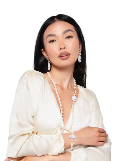 Model wearing a parure in 925 sterling silver with freshwater pearls and cameo