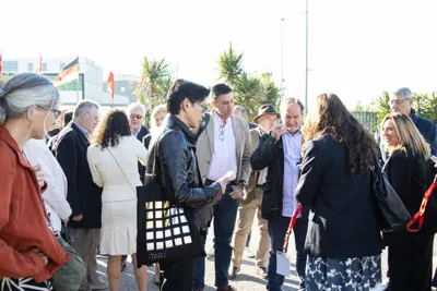 Buyers gathered outdoors in conversation before a visit.