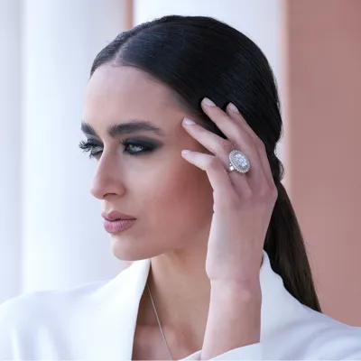 Model wearing an Elisabetta Collection ring in sterling silver with cubic zirconia and a flower cameo on sardonyx shell
