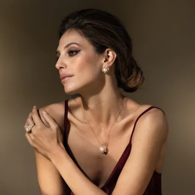 Model wearing a necklace, earrings and ring in 18-karat yellow gold with South Sea pearls and diamonds