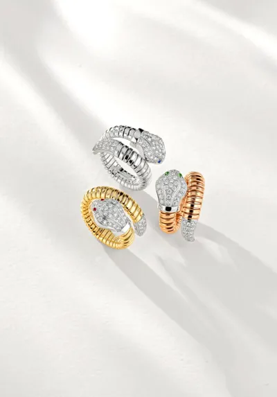 Three Tubogas snake rings in white, yellow and rose gold set with diamonds