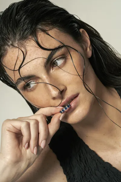 Model wearing 18-karat gold trilogy and eternity rings with natural diamonds, Maratea collection