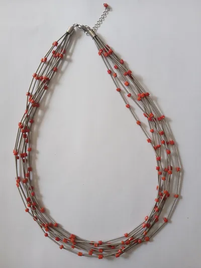 Necklace of red coral beads on stainless steel wires