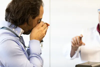 A buyer inspecting a jewel through a loupe.
