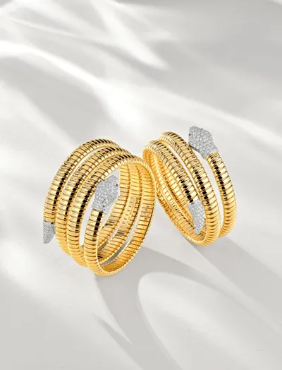 Two yellow gold Tubogas coil bracelets ending in diamond-set snake heads