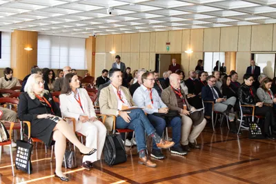 The audience seated in the conference room during the opening presentation of the 2025 edition.