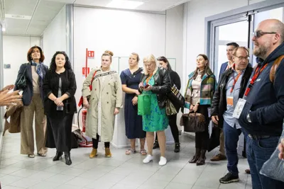 A group of buyers listening to a guide in a corridor of the centre.