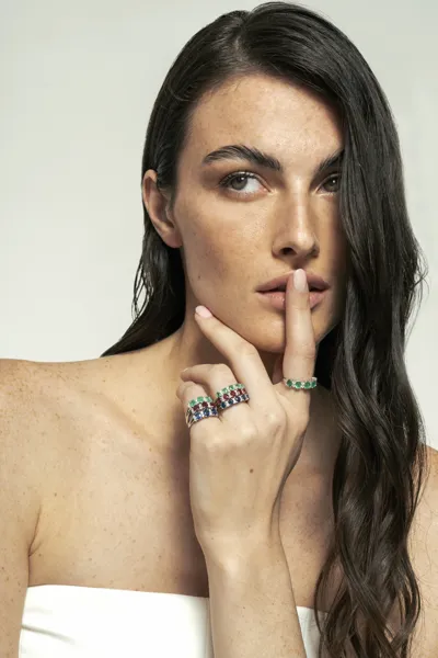 Model wearing 18-karat gold trilogy and eternity rings with natural diamonds, Mondello collection