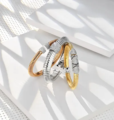 Three Tubogas bangles in rose, white and yellow gold with diamond pavé triangular ends