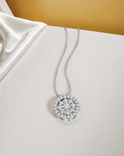 Diamond pendant necklace from the Clock collection on white satin