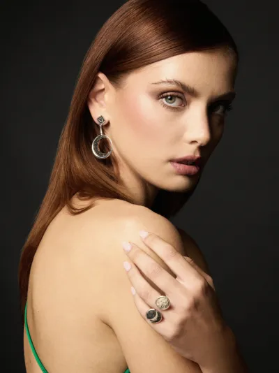 Model in profile wearing a silver moon earring and ring from the Moonphases collection