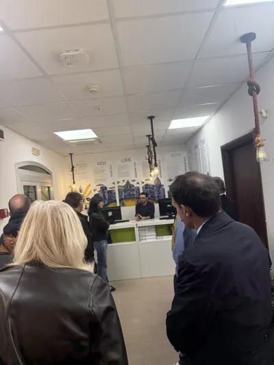 Visitors seen from behind in an exhibition room.