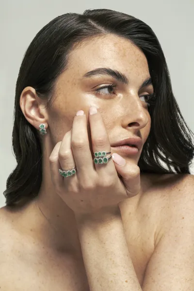 Model wearing 18-karat gold trilogy and eternity rings with natural diamonds, Tropea collection
