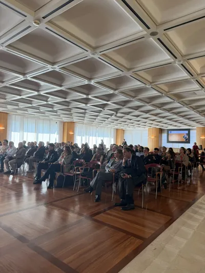 A wide view of the audience in the conference hall.