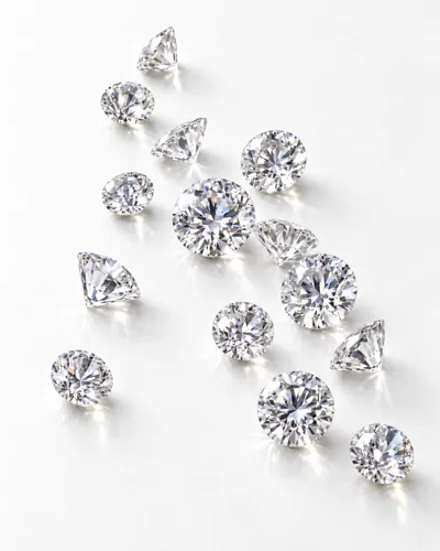 Loose round brilliant-cut natural diamonds on a white surface