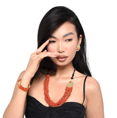 Model wearing a parure in 925 sterling silver with coral and onyx