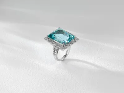 Ring with a rectangular light blue stone framed by diamonds, in white gold