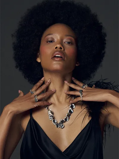 Model wearing silver rose rings and a silver necklace from the Bouquet Noir collection