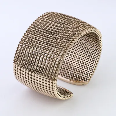 Wide gold cuff bracelet mounting with a grid of empty stone settings