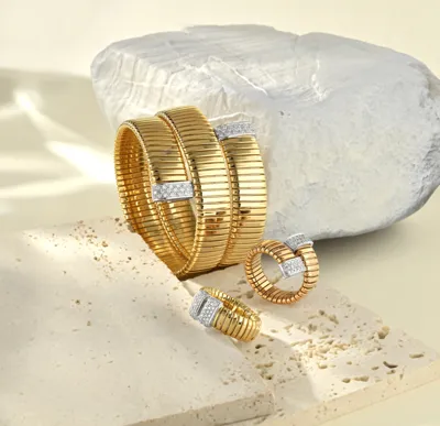 Yellow gold Tubogas wrap bracelet and two rings with diamond pavé bars