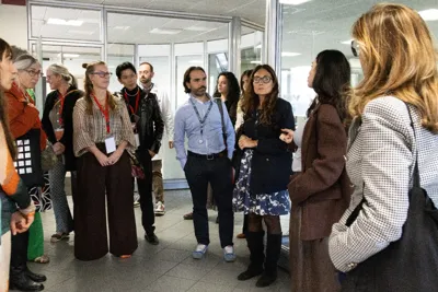 A group of buyers listening during a visit to the workshops.