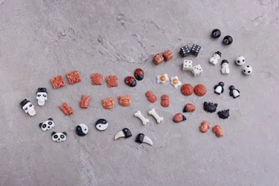 Small carved figures in coral and other materials, including skulls, pandas and dice
